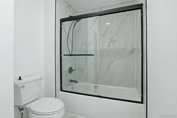 a bathroom with a shower and a toilet