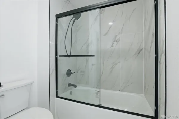 a bathroom with a shower and a toilet