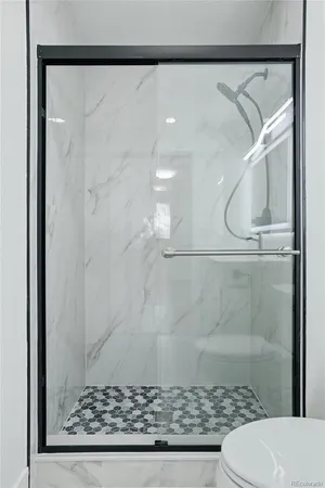 a bathroom with a glass shower door