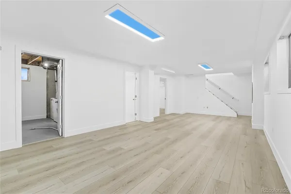 a view of an empty room and wooden floor