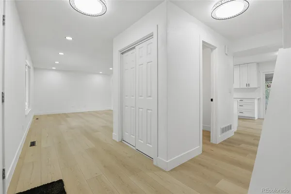 a view of a hallway with wooden floor