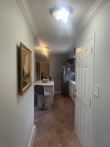 a view of a hallway with entryway to bedroom