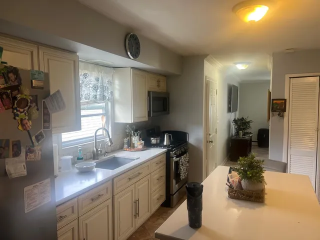 a kitchen with a sink stove and refrigerator