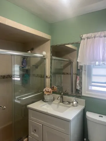a bathroom with a sink a mirror and a shower
