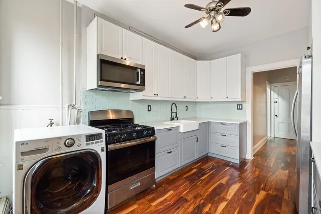 a kitchen with stainless steel appliances granite countertop a stove and a sink