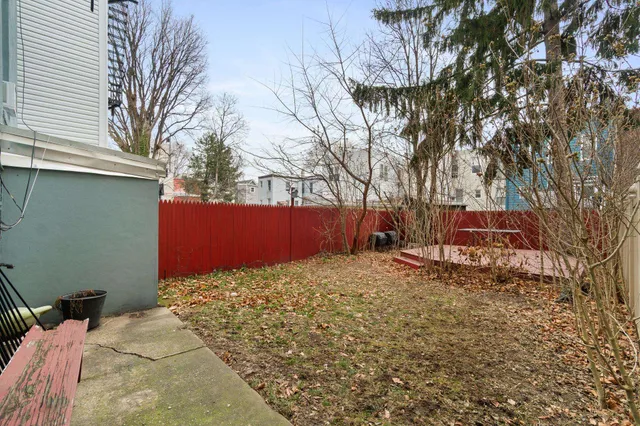 a bed sitting in a bedroom next to a large window
