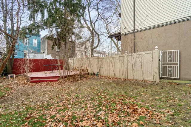 a white house that has tree in front of it