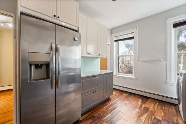 a kitchen with stainless steel appliances a refrigerator and a window