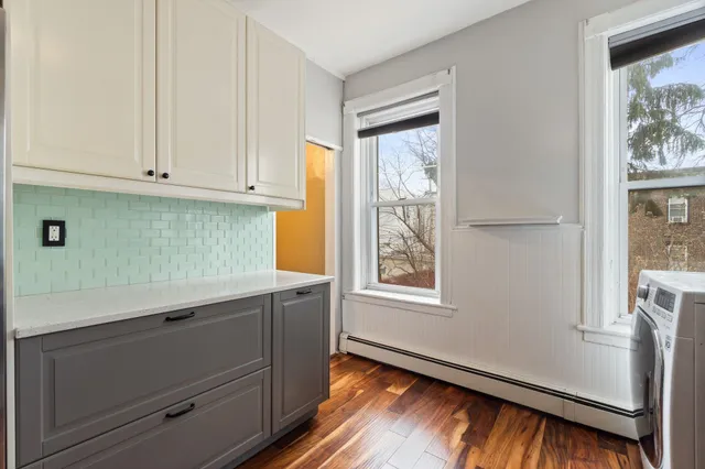 a room with hard wood floors and a window