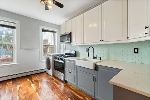 a kitchen with a sink cabinets and window