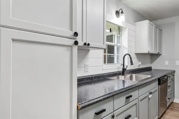 a kitchen with a sink and cabinets