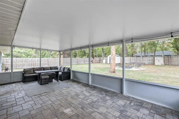 a living room with furniture and a floor to ceiling window