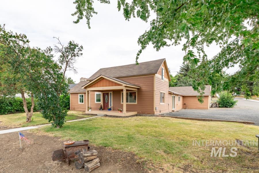 306 West Chestnut Street Genesee, ID 83832 - Photo 1 of 1 View of front of house with a front yard, driveway, a patio, and roof with shingles