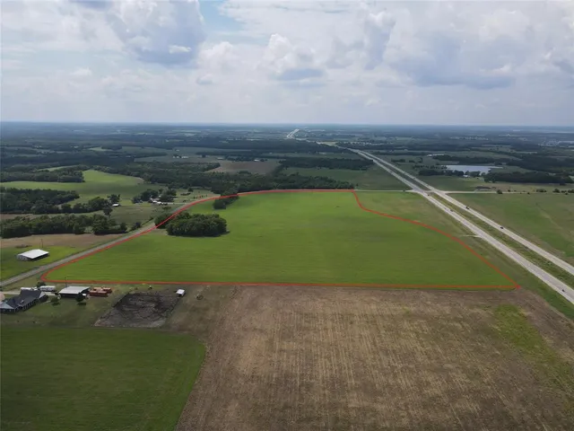 an aerial view of a golf course with a lake view
