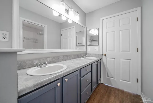 a bathroom with a granite countertop sink a large mirror and a vanity