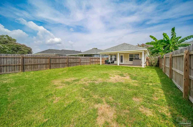 a view of a house with a garden and a yard