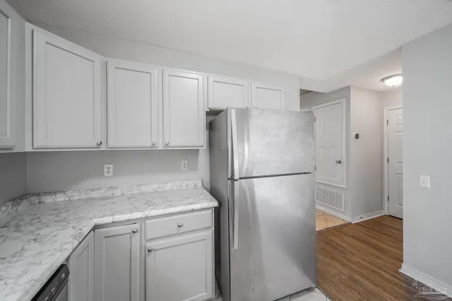 a white refrigerator freezer sitting inside of a kitchen