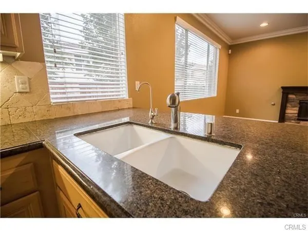 a view of a kitchen with a sink and a large window