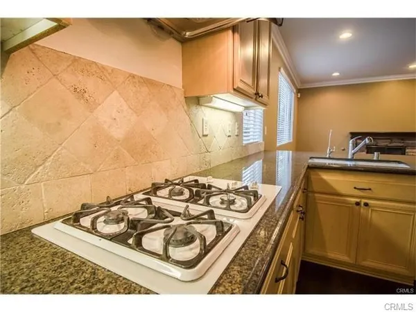 a kitchen with a stove a sink and a cabinets