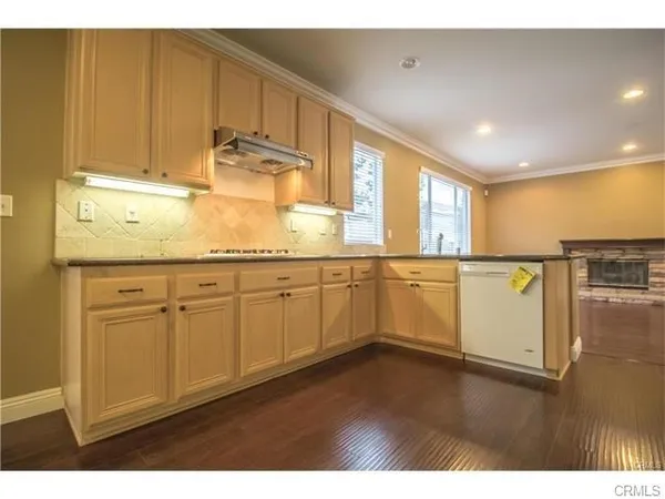 a kitchen with a sink cabinets and wooden floor