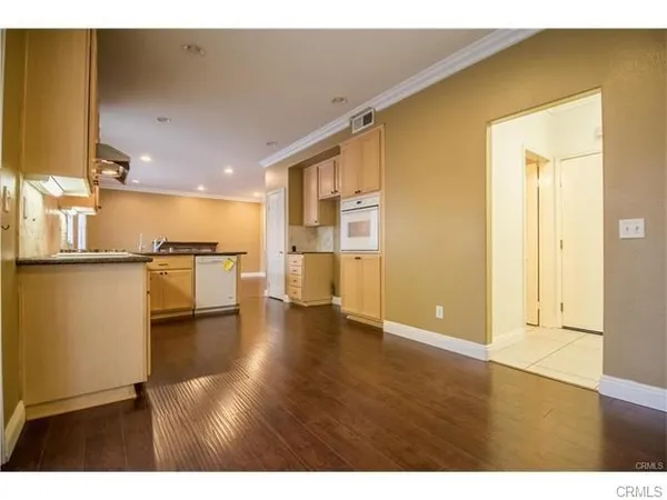 a view of a kitchen with a sink and a refrigerator