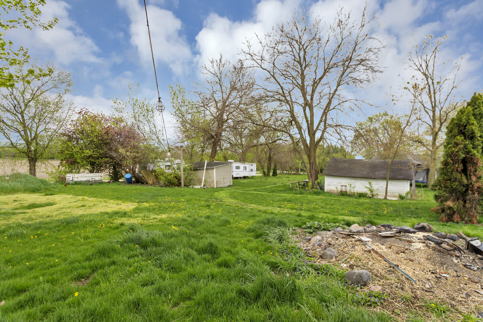 18912 River Road Marengo, IL 60152 - Photo 26 of 31 a view of a house with a big yard and large trees