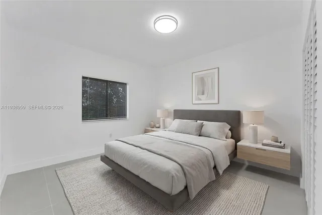 a bedroom with a bed and a lamp