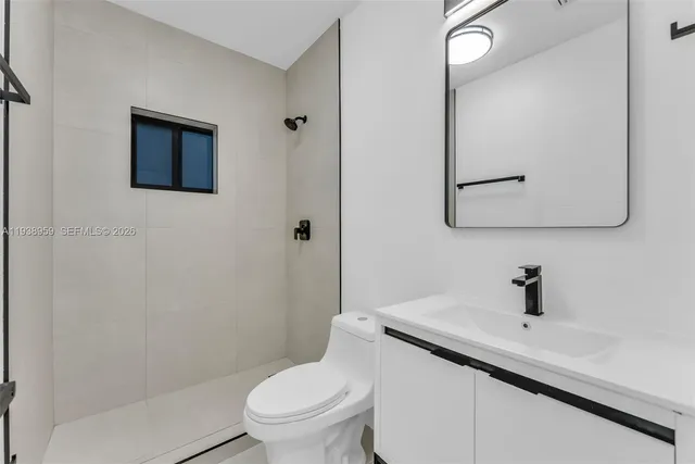 a bathroom with a sink a mirror and a toilet