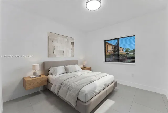 a bedroom with a bed and a painting on the wall