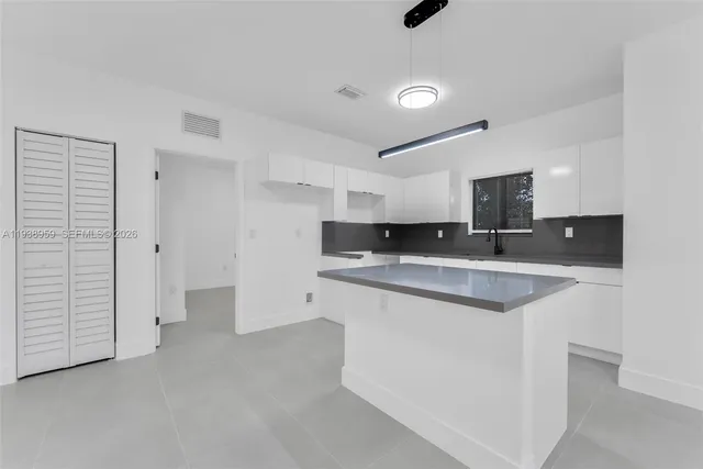 a large kitchen with cabinets and stainless steel appliances