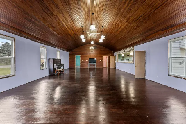 a view of a livingroom with hardwood floor and staircase