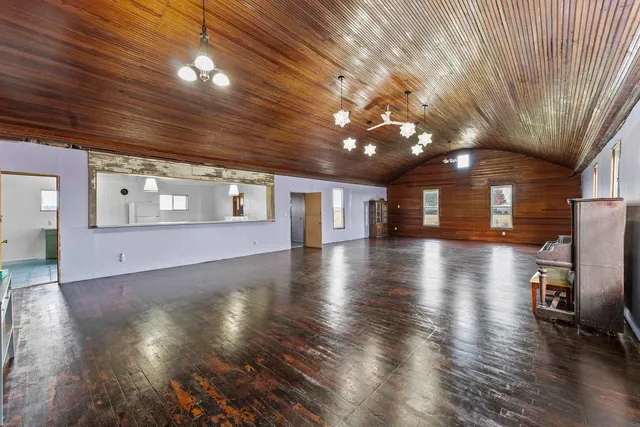 a view of a hall with wooden floor