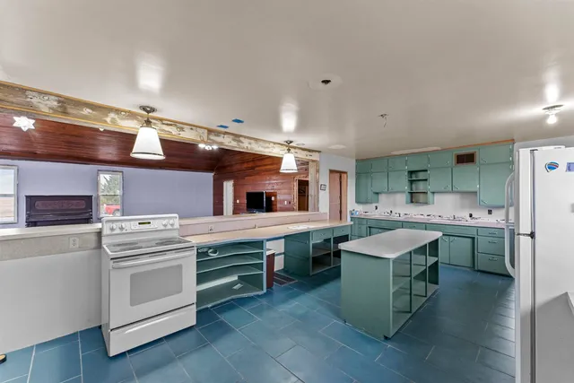 a kitchen with a stove a sink and a refrigerator