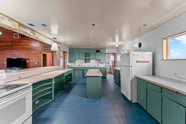 a kitchen with a cabinets and white stainless steel appliances