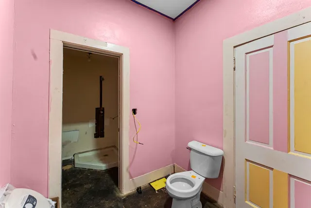a bathroom with a granite countertop toilet sink and a mirror