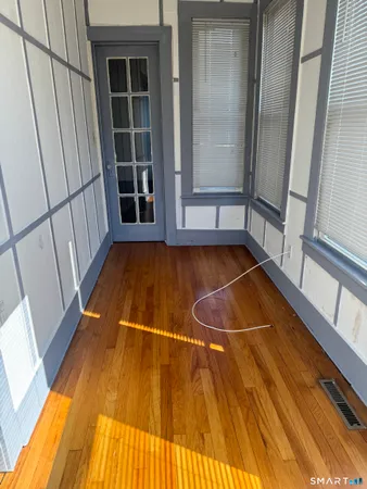 a view of front door with wooden floor