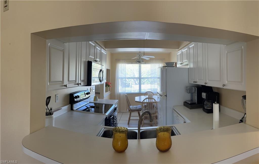 185 Grand Oaks Way, Unit R204 Naples, FL 34110 - Photo 2 of 18 a room with gym equipment and windows
