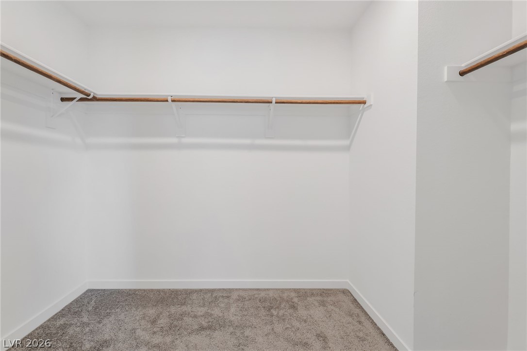 894 Cadence View Way Henderson, NV 89011 - Photo 17 of 23 Well-designed space providing ample room for wardrobe essentials, featuring sturdy closet rods.