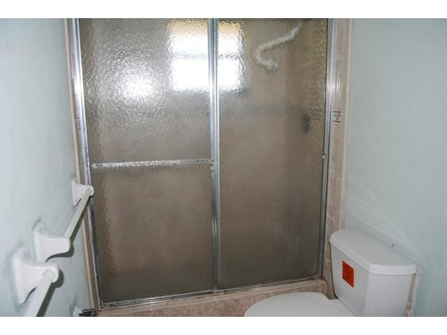 3976 Inverrary Drive, Unit C4 Lauderhill, FL 33319 - Photo 6 of 11 a bathroom with a shower and a toilet