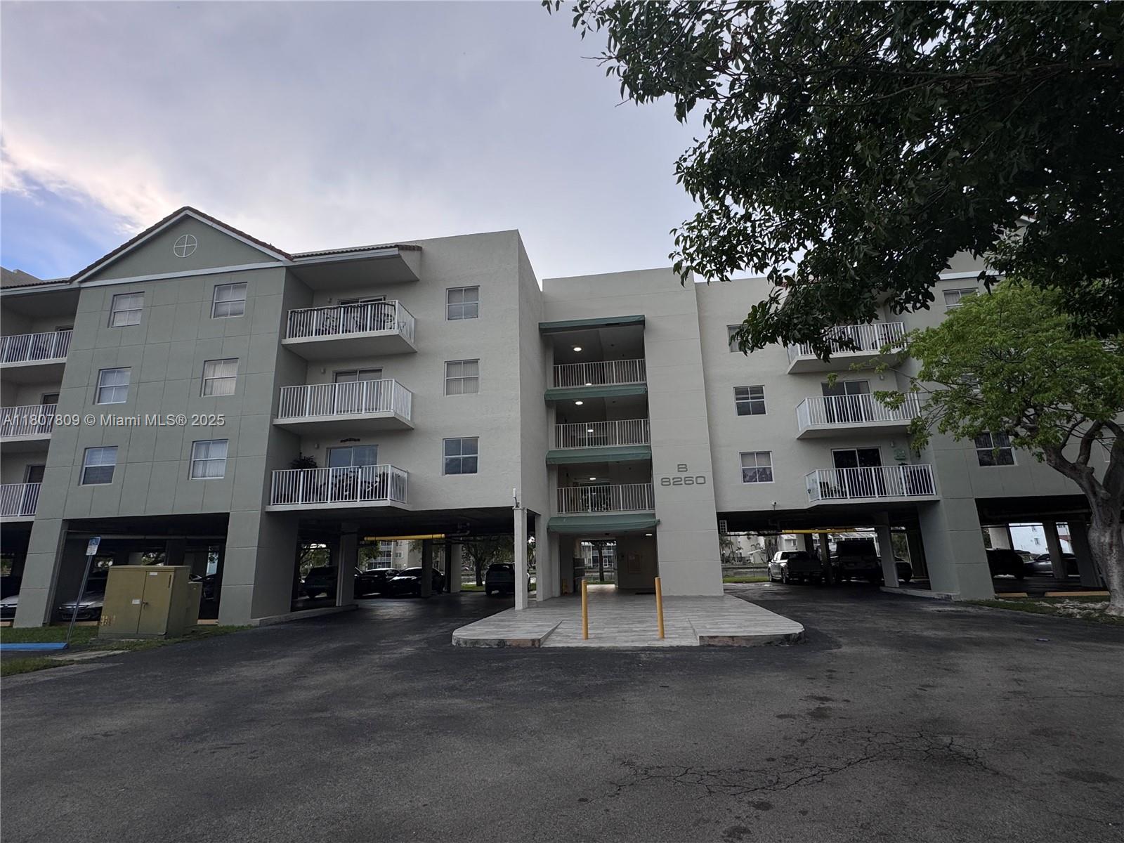 8260 Southwest 210th Street, Unit 310 Cutler Bay, FL 33189 - Photo 1 of 14 a front view of a building with street