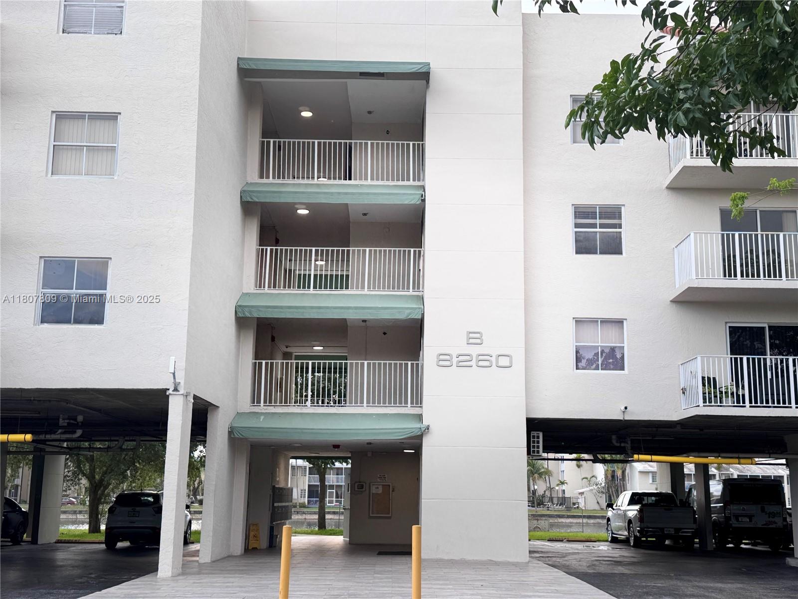 8260 Southwest 210th Street, Unit 310 Cutler Bay, FL 33189 - Photo 2 of 14 a front view of building with cars parked