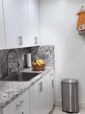 a kitchen with a sink and cabinets