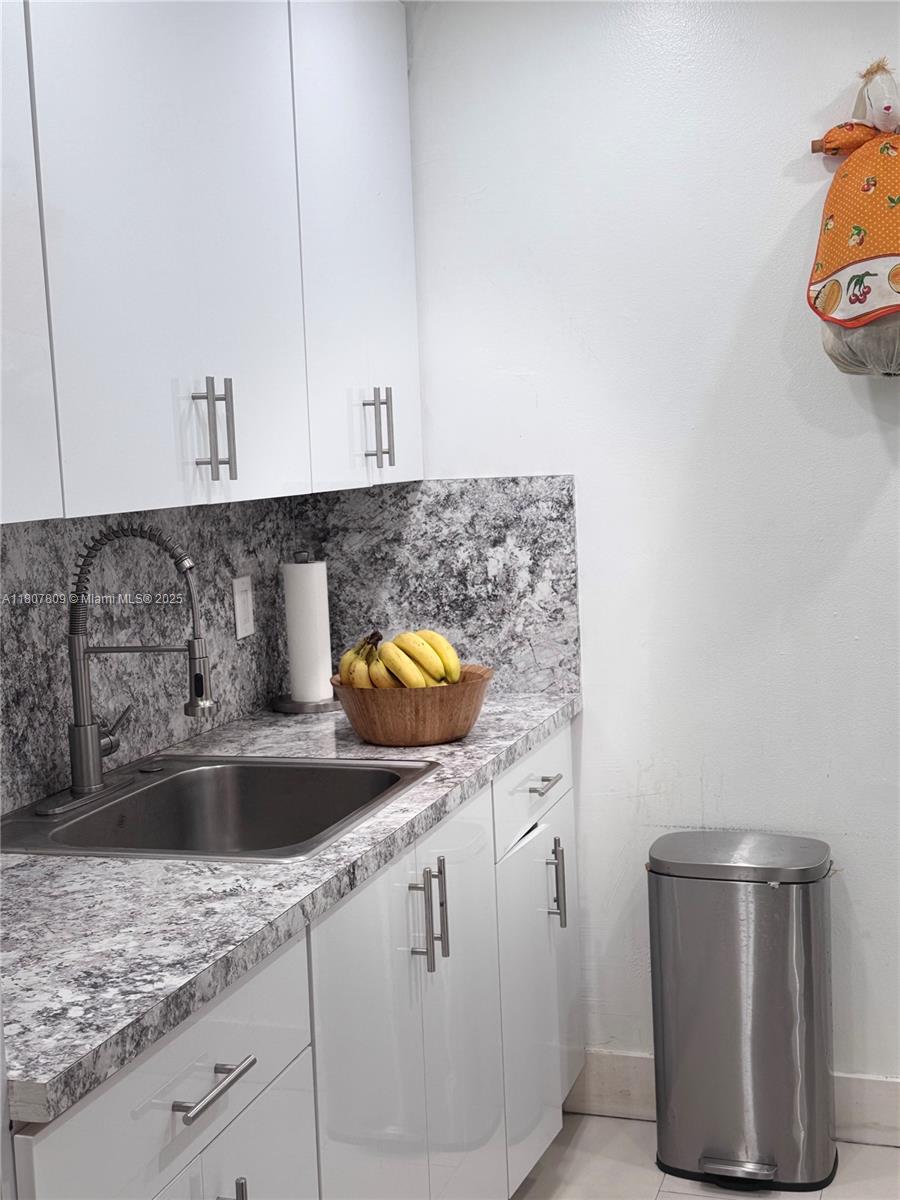 8260 Southwest 210th Street, Unit 310 Cutler Bay, FL 33189 - Photo 4 of 14 a kitchen with a sink and cabinets