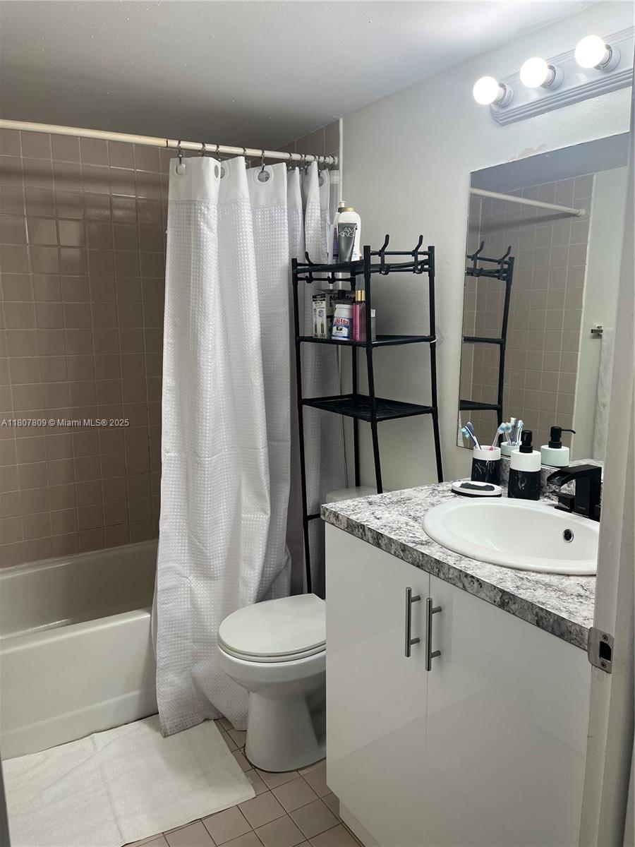 8260 Southwest 210th Street, Unit 310 Cutler Bay, FL 33189 - Photo 10 of 14 a bathroom with a sink a toilet and shower