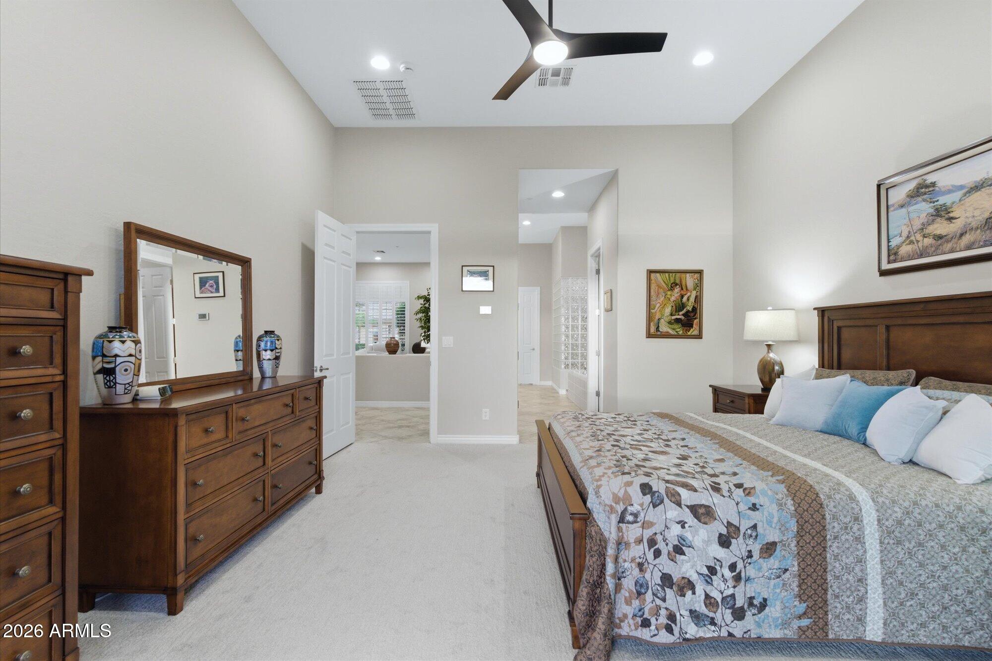 40322 North Hawk Ridge Trail Anthem, AZ 85086 - Photo 28 of 63 a bedroom with a large bed and a couch