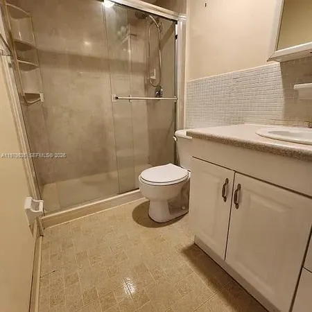 a bathroom with a shower and a toilet