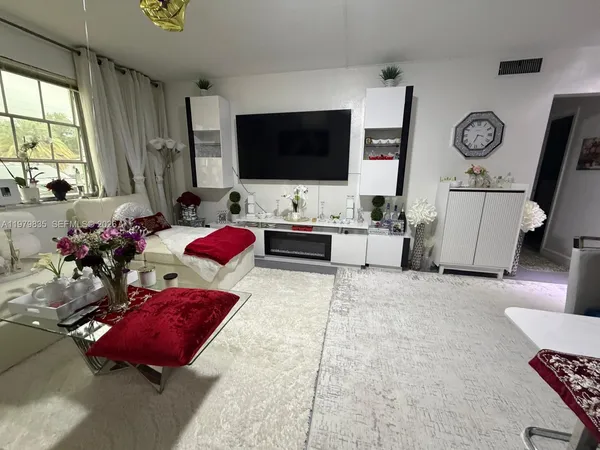 an empty room with windows and ceiling fan