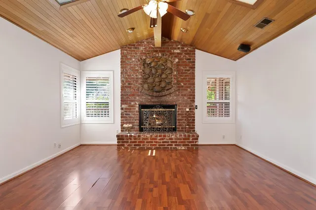 a view of a kitchen with a sink and wooden floor