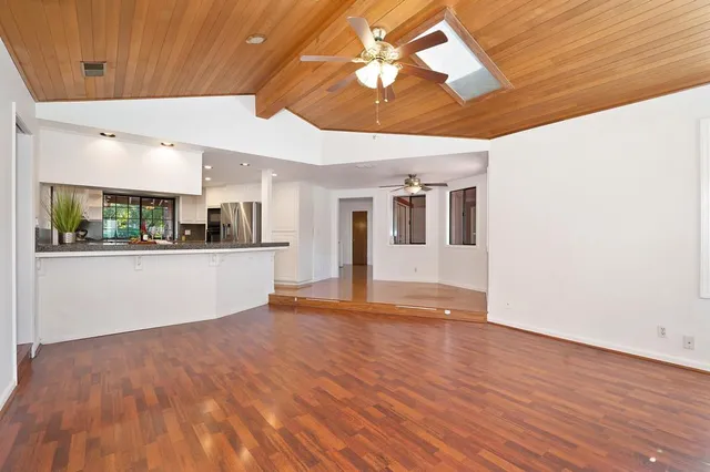 a kitchen with stainless steel appliances granite countertop a sink and a refrigerator
