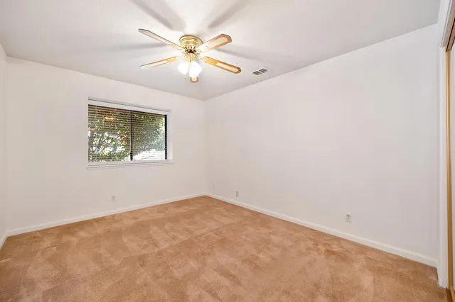 a bathroom with a granite countertop sink a mirror and a bathtub